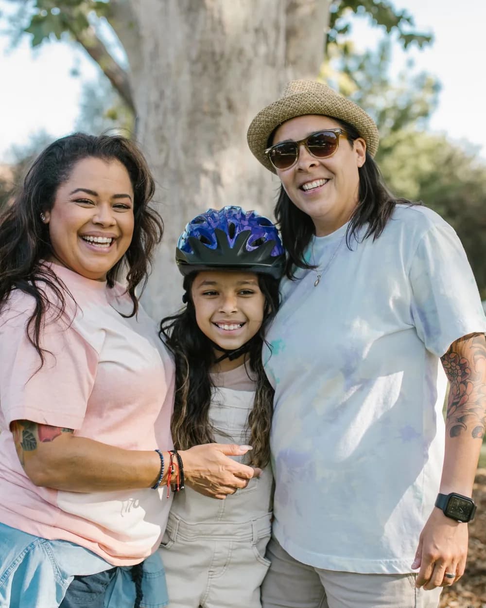 A family smiling together outdoors after family counseling