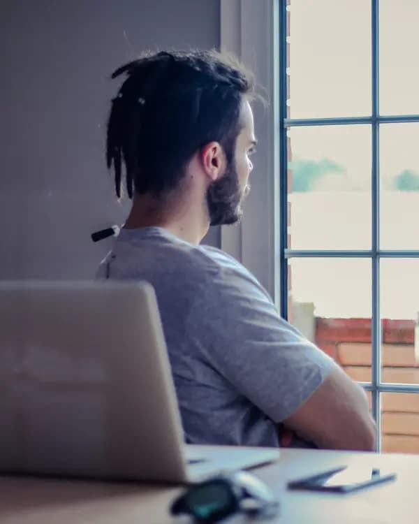 Man gazing out a window in quiet reflection