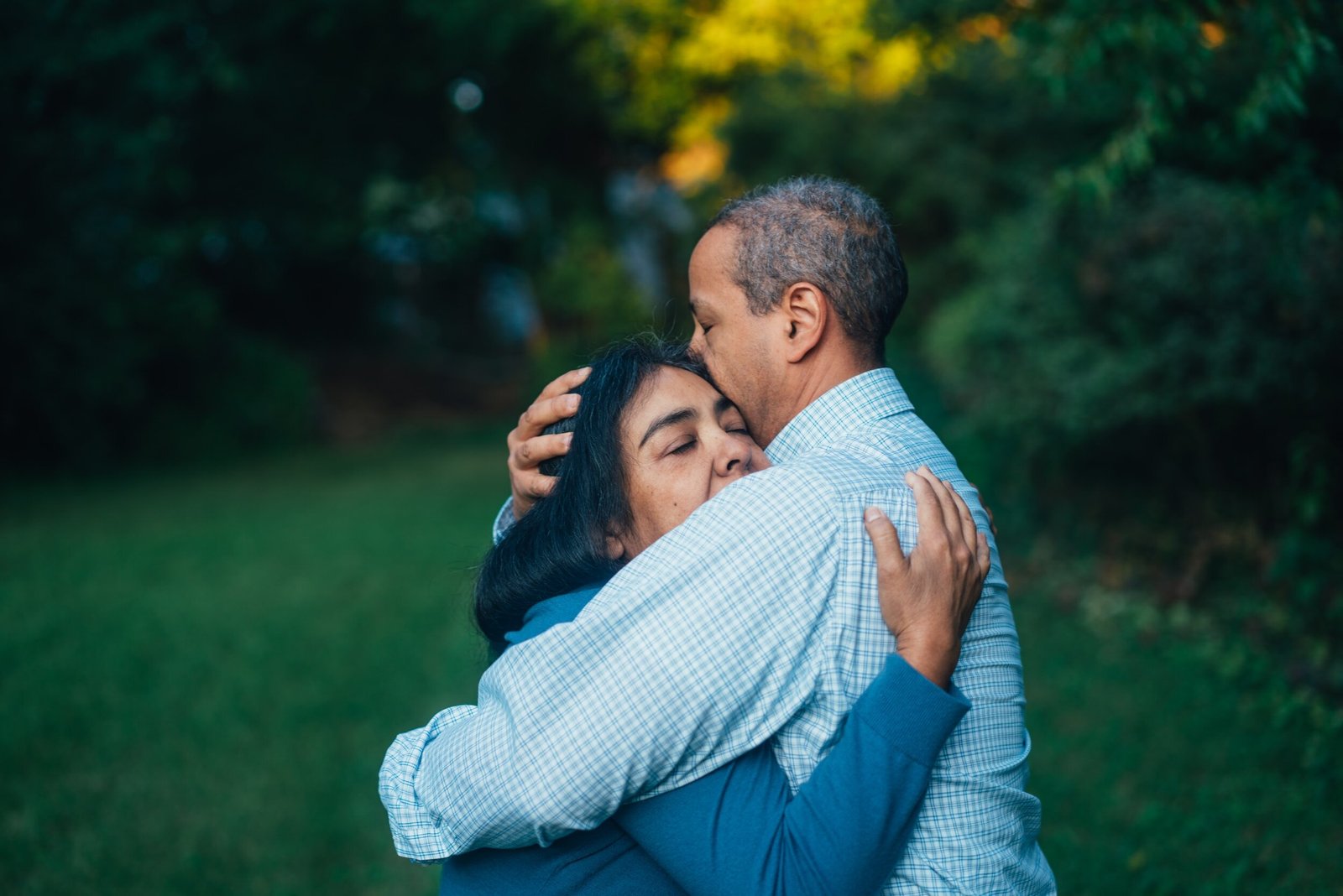 a couple hugging in the yard