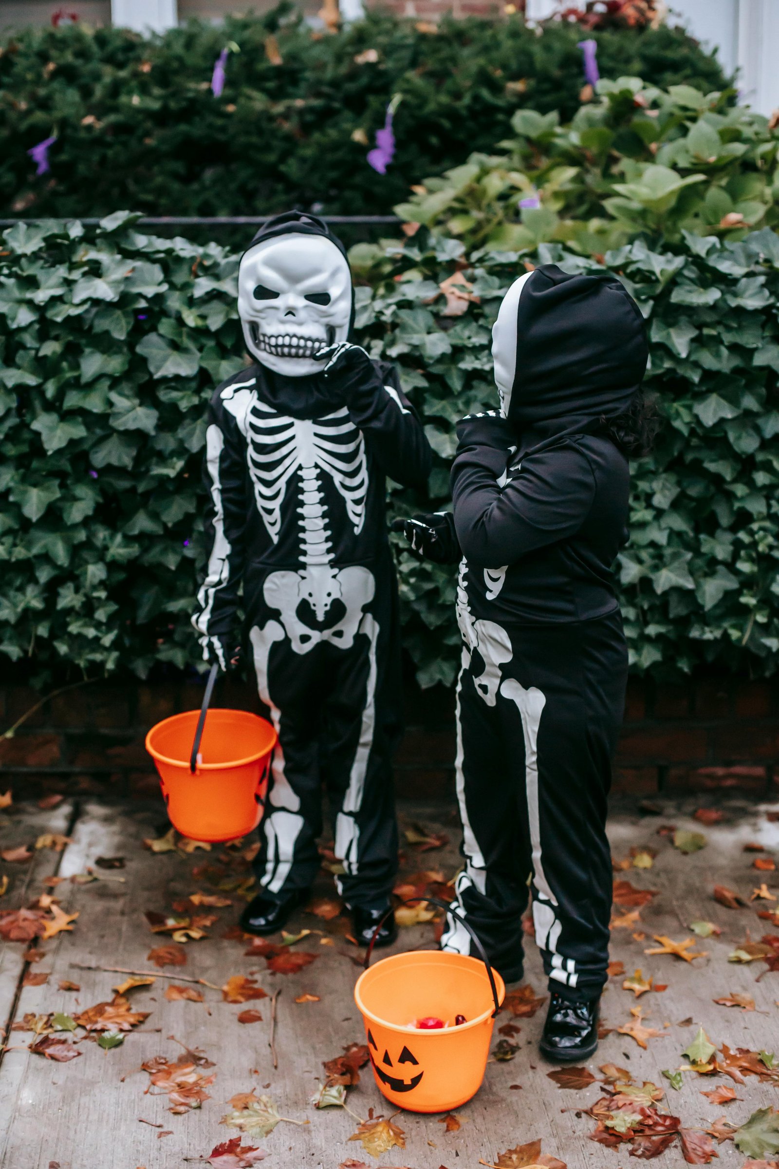 Two kids in costumes trick-or-treating