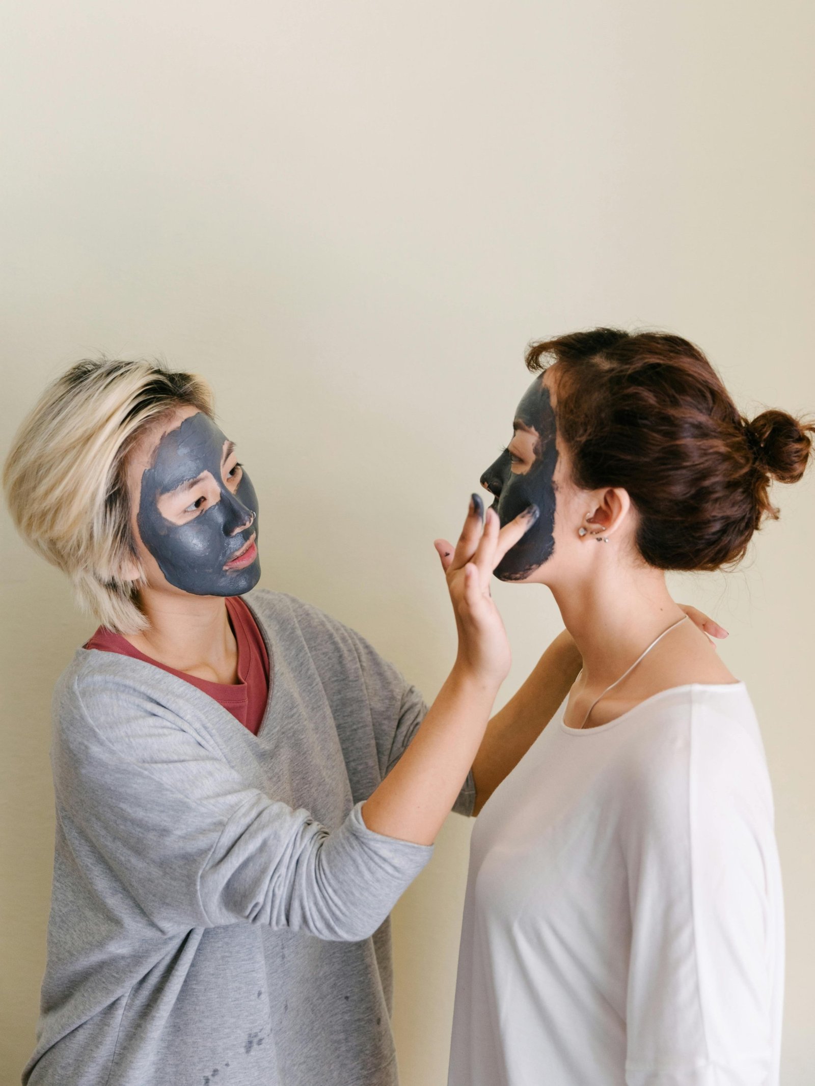 two women applying face masks and doing self-care